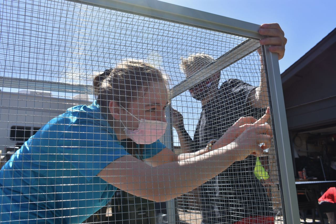 Scout installing screen walls