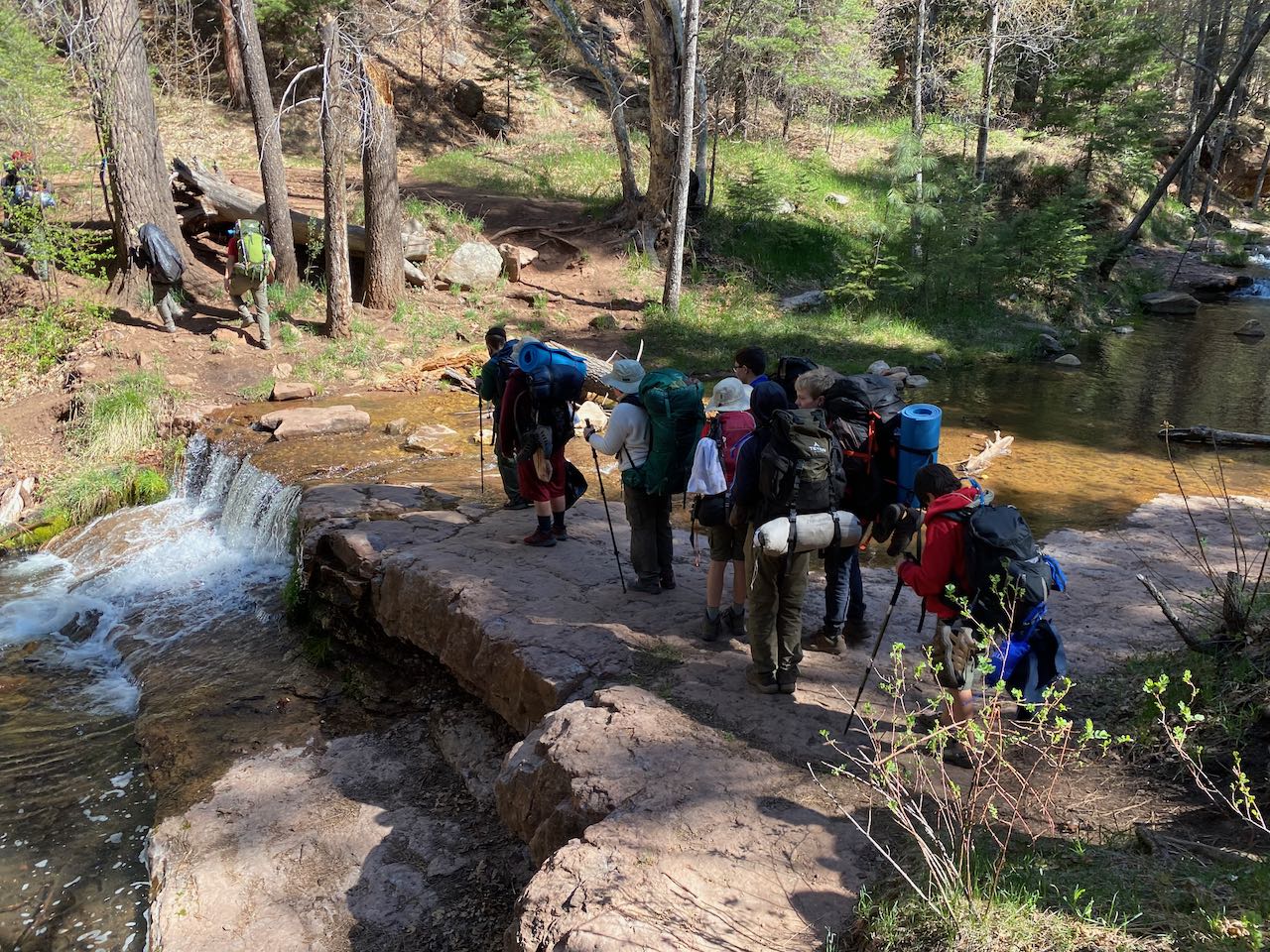 Hikers crossing creek